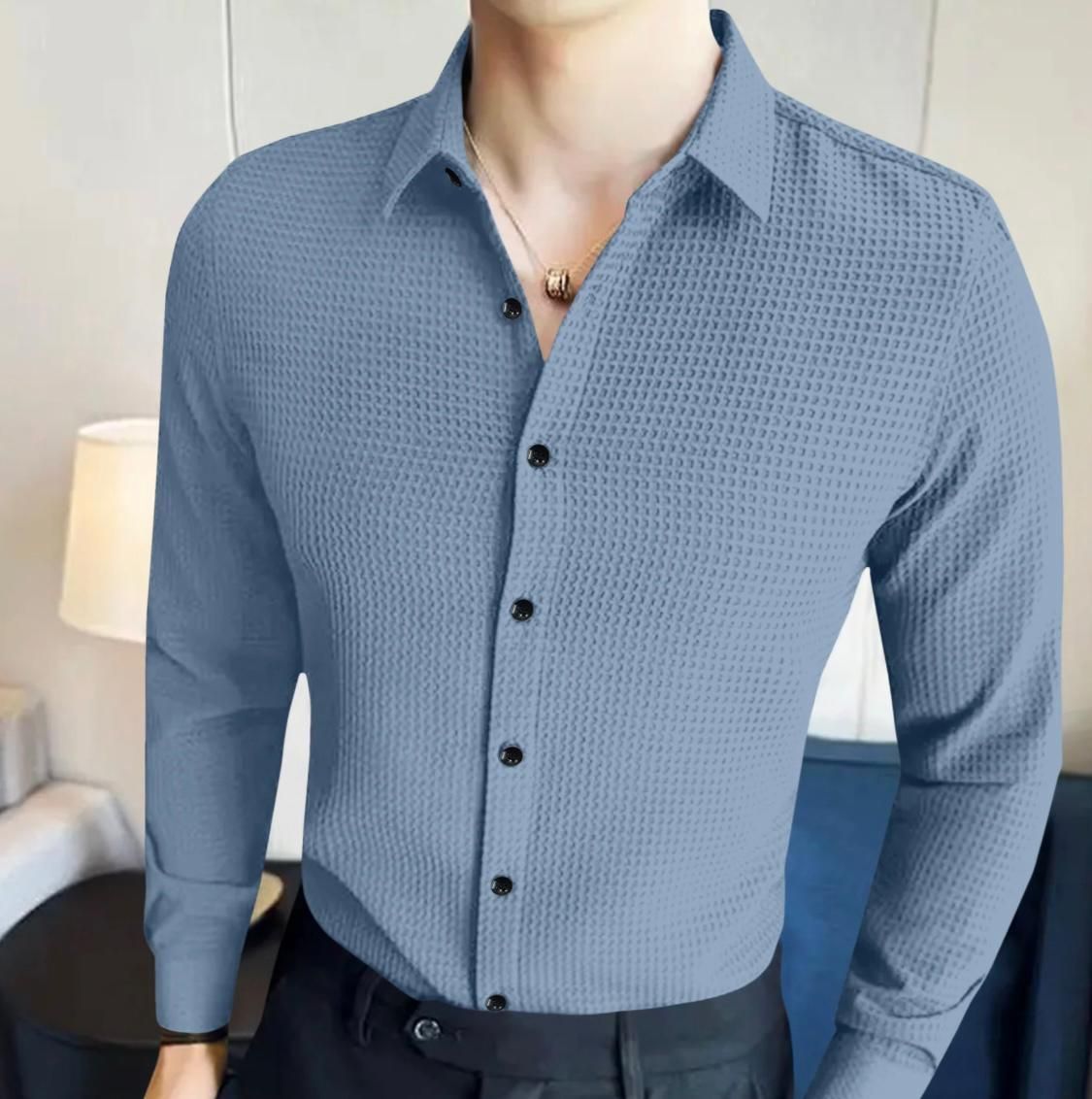Blue textured shirt on a mannequin against a neutral background