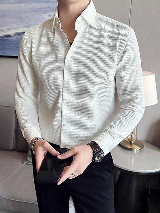Person wearing a white textured shirt and black pants in an indoor setting.